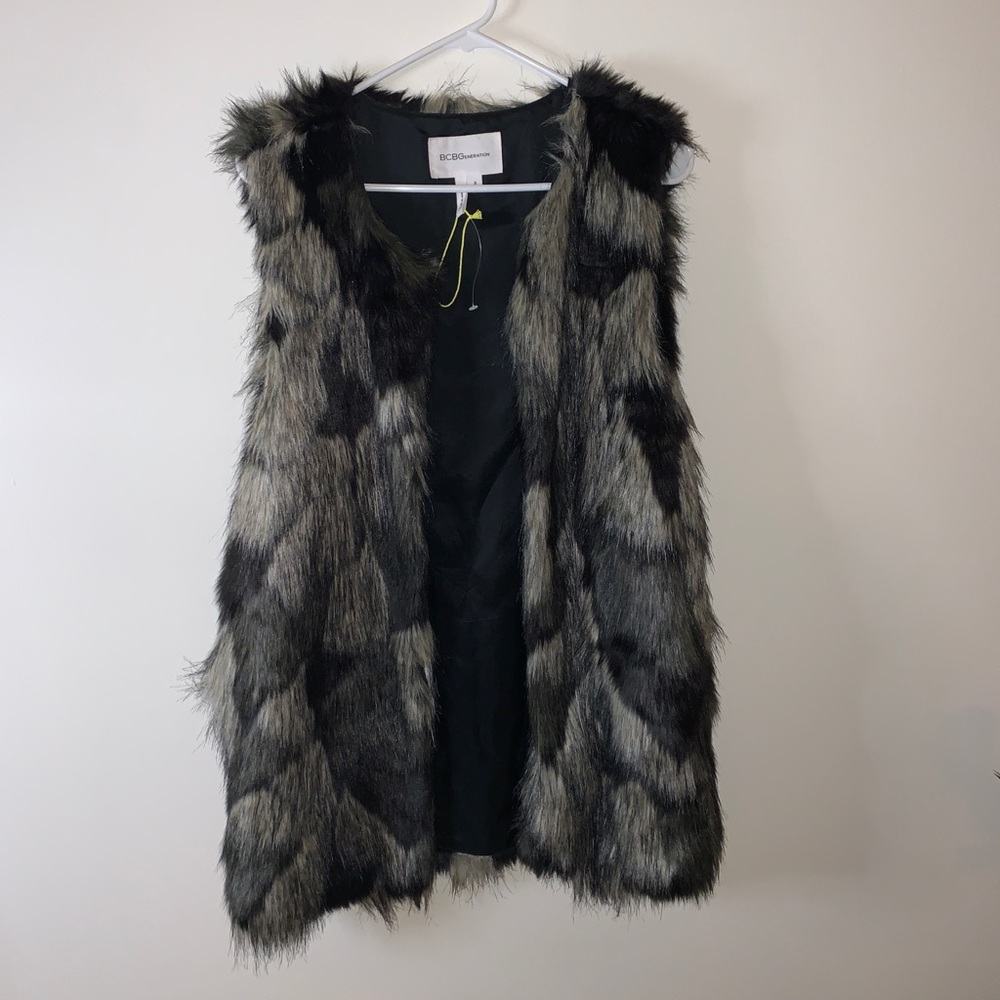 BCBG faux  fur vest
Great for dressing up or down 
Lightly worn